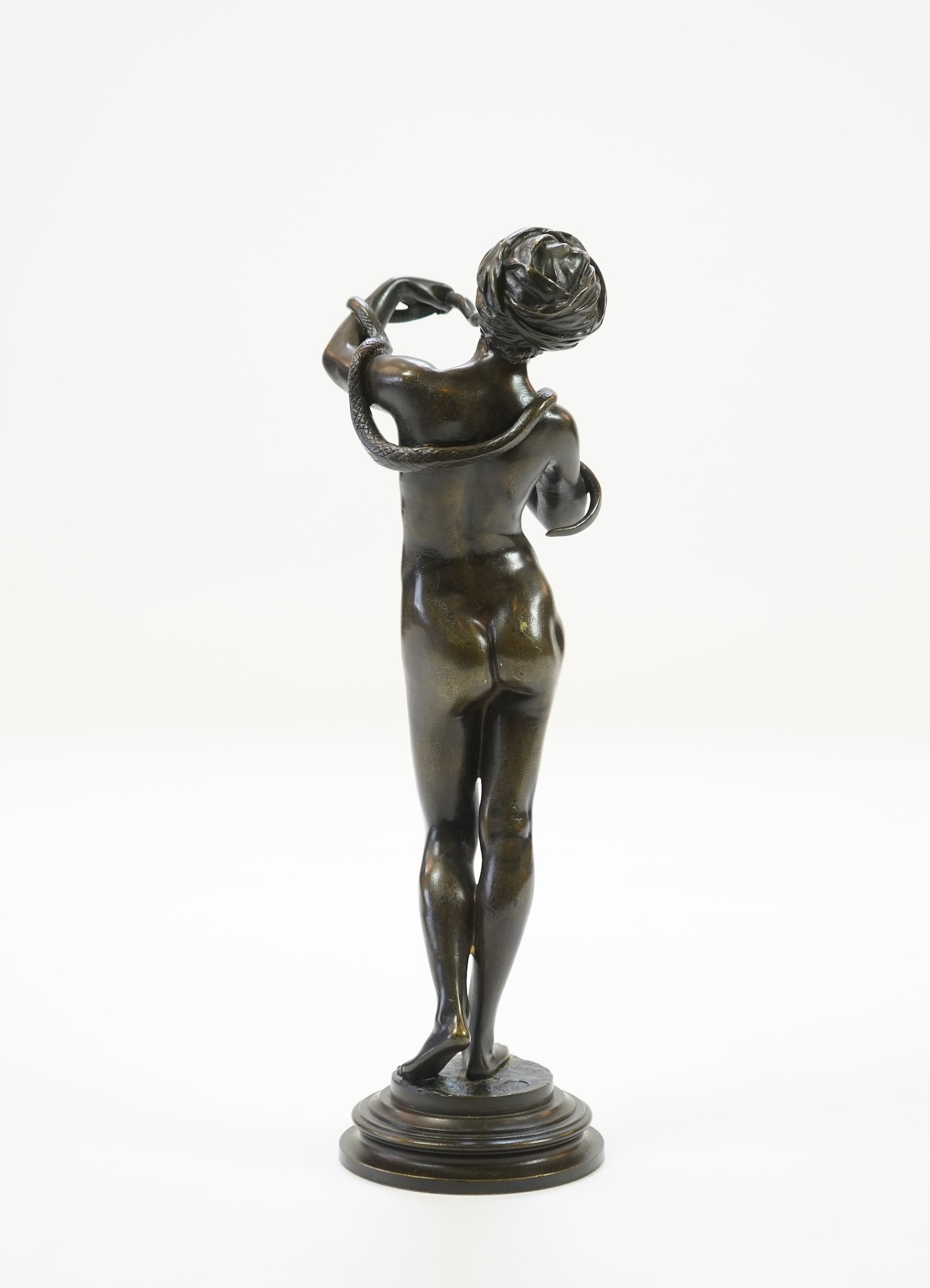 Josef Wind (German, 1864-1889). A patinated bronze of a nude female snake charmer